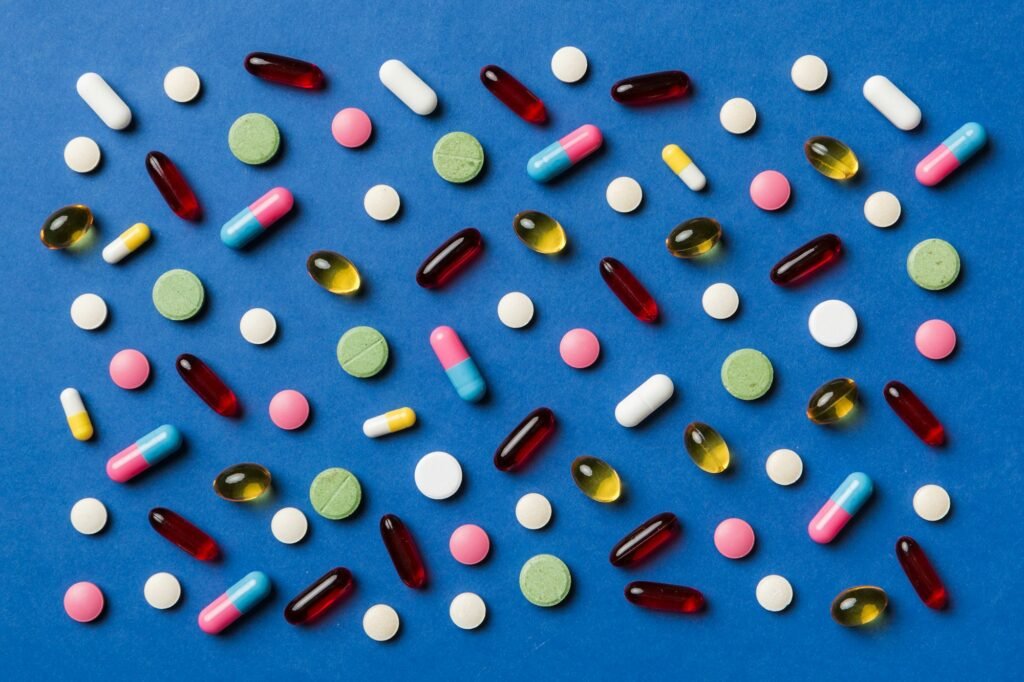 Many different pills and space for text on colorful background, top view. Different pills